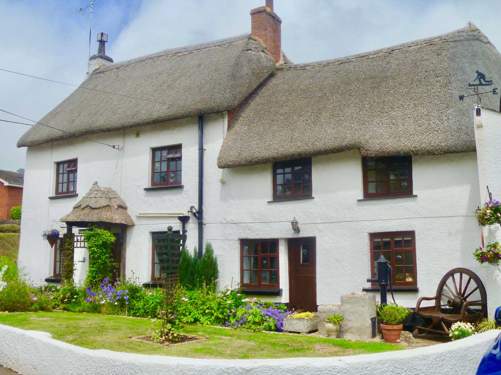 A semi-detached cottage with thatched roof somewhere in Devon